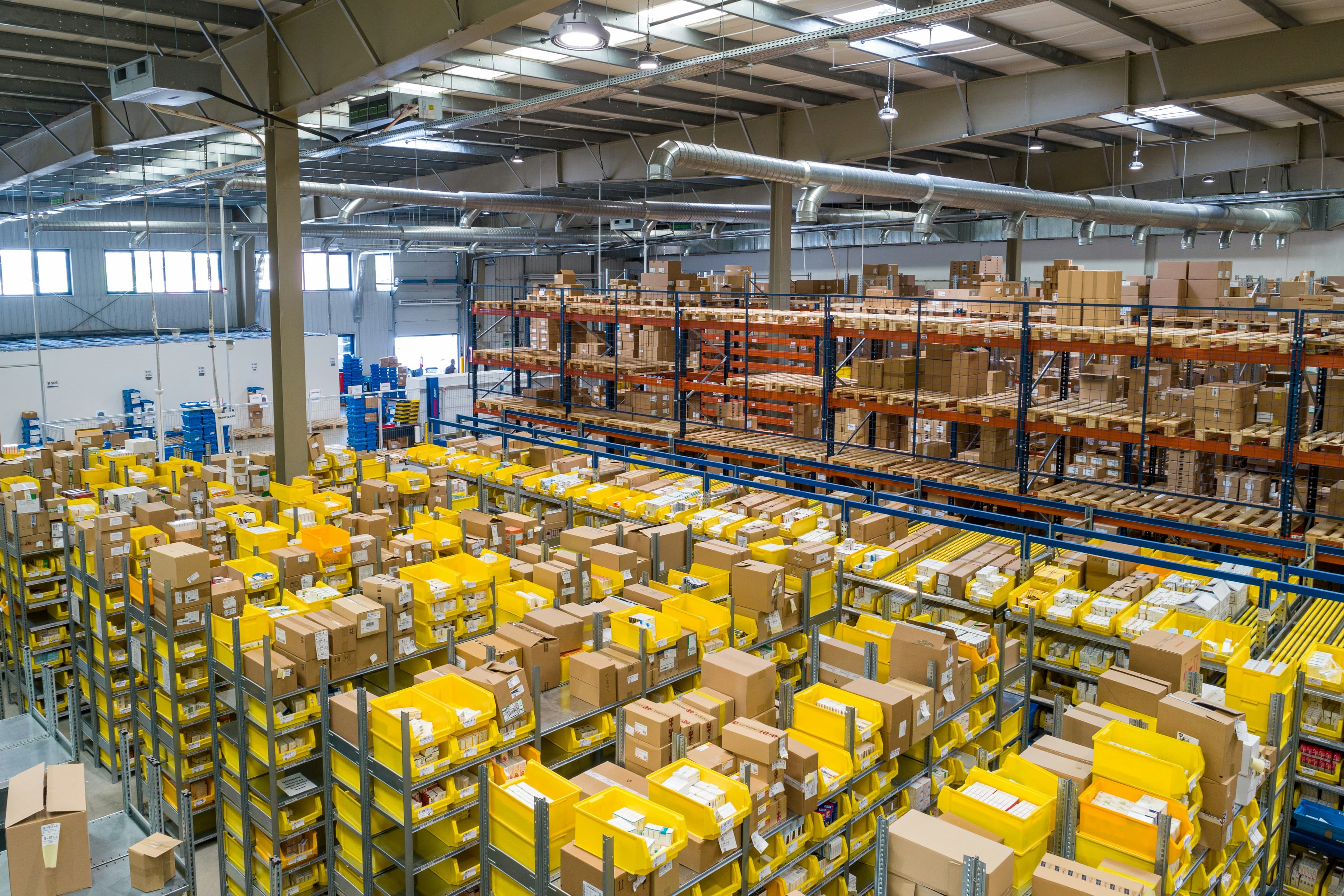 Rows of pallets and racking inside a large logistics warehouse